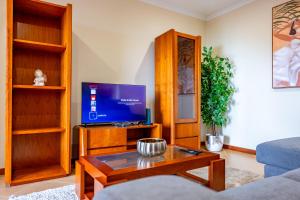 a living room with a tv and a coffee table at View to the Valley, By OP in Senhora do Rosário
