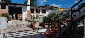 a house with a pool and a person standing in the doorway at Casa Ximendes in São Gabriel