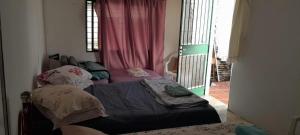 a room with two beds in a room with a window at Casa Ximendes in São Gabriel