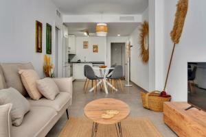 a living room with a couch and a table at Bon Dia Moraira in Moraira
