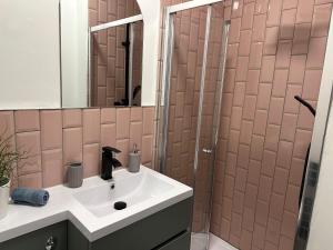 a bathroom with a sink and a shower at Norton Rd Guest House in Stockton-on-Tees +8 photos