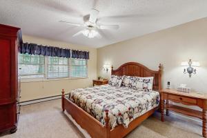 a bedroom with a bed and a ceiling fan at Lakeledge Hideaway in Beech Mountain