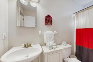 a white bathroom with a sink and a toilet at Lakeledge Hideaway in Beech Mountain