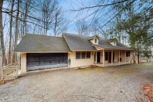 a small white house with a garage at Lakeledge Hideaway in Beech Mountain