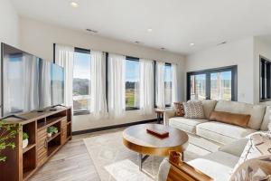 a living room with a couch and a tv at The 19th Hole in Sturgis