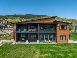 a large house with a deck and a yard at The 19th Hole in Sturgis