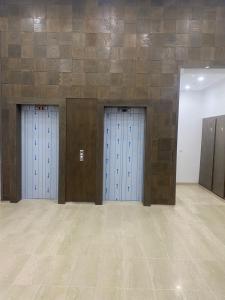 a room with three blue lockers on a wall at Lux app ain zaghouen in Tunis