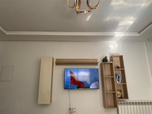 a tv on a wall in a room at Lux app ain zaghouen in Tunis