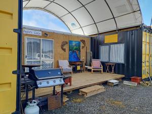 a house with an outdoor deck with a grill at Wharf Street Art in Foxton