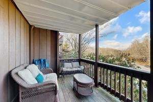 a porch with wicker chairs and a balcony with a view at Cloud Nine Mountain Home in Sugar Mountain
