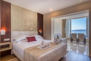 a bedroom with a bed with a view of the ocean at Villa Višnja in Brela