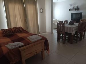 a bedroom with a bed and a table and chairs at Casa en Ataliva Roca in Ataliva Roca