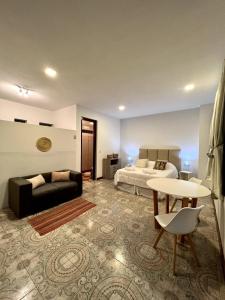 a living room with a bed and a couch and a table at Welindo Loft in Salta