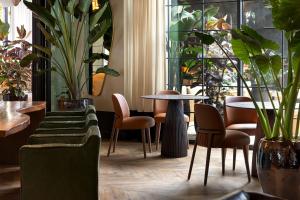 a room with tables and chairs and plants at Kimpton La Peer West Hollywood by IHG in Los Angeles