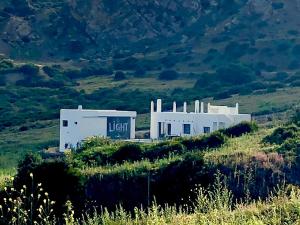 a white building on the side of a hill at Dar-west in Demina