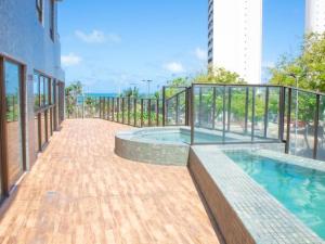 a swimming pool on a balcony of a building at Cobertura vista mar in Natal