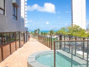 a balcony of a building with a swimming pool at Cobertura vista mar in Natal