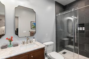 a bathroom with a toilet and a sink and a shower at The Optimist Guesthouse | 5 in Camden +14 photos