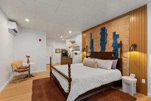 a bedroom with a large bed with a wooden headboard at The Optimist Guesthouse | 5 in Camden