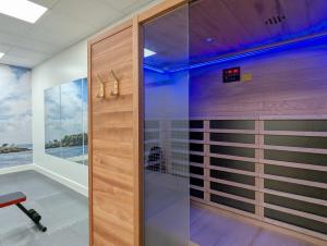 a walk in shower in a room with a window at The Optimist Guesthouse | 5 in Camden