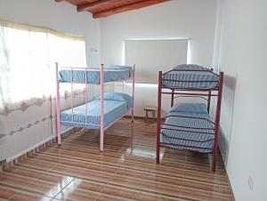 two bunk beds in a room with a window at Los Talitas in Villa Parque Siquiman +20 photos