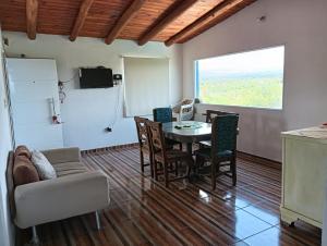 a living room with a table and a couch at Los Talitas in Villa Parque Siquiman