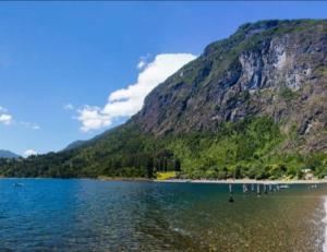 a view of a lake in front of a mountain at Casa Entre Cerros in Futrono