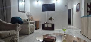a living room with a tv and a glass of wine at Villas De Morne in Castries