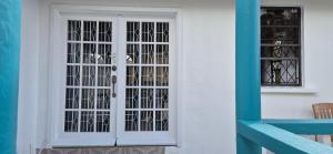 a white door with glass panels on a building at Villas De Morne in Castries