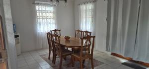 a dining room with a wooden table and chairs at Villas De Morne in Castries