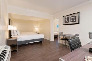una camera d'albergo con un letto e una scrivania di El Castell Motel a Monterey