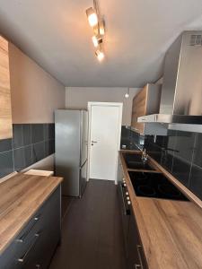 a kitchen with a stainless steel refrigerator and wooden counters at Perfect for longer stays in Heinsberg