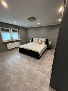 a bedroom with a bed and a tiled floor at Perfect for longer stays in Heinsberg