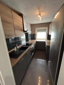 a kitchen with stainless steel appliances and a window at Perfect for longer stays in Heinsberg