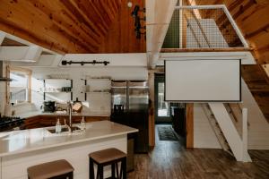 a kitchen with a large whiteboard on the wall at Emerald Escape in Grayling