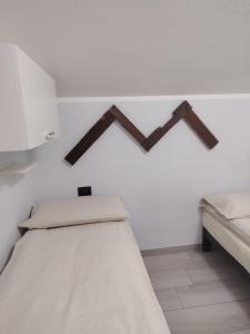 a bedroom with a bed with two crosses on the wall at Lika in Livigno
