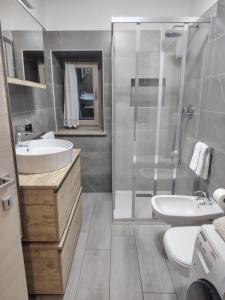 a bathroom with a shower and a sink and a toilet at Lika in Livigno +8 photos