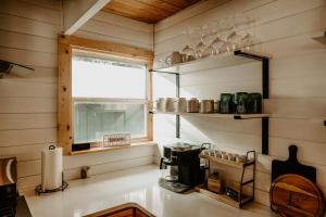 a kitchen with a window and a coffee maker at Emerald Escape in Grayling