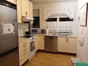 a kitchen with a refrigerator and a sink at Quiet, two bedroom apartment in Reykjavík