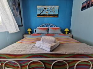 a blue bedroom with a bed with towels on it at Patty's House Kallikratia in Vergia +53 photos