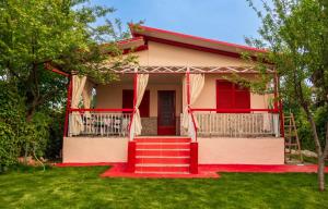 a small house with red trim and a red door at Patty's House Kallikratia in Vergia