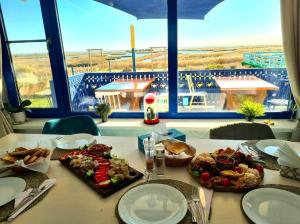 a table with plates of food on top of it at Agropensiunea Paradisul Verde in Jurilovca