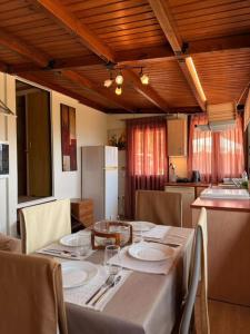 a kitchen with a table with plates and wine glasses at Agnanti in Riglia +11 photos