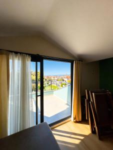 a room with a large window with a view at InOut Social in Fethiye