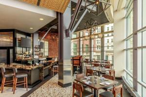 a restaurant with tables and chairs and a bar at Renaissance Allentown Hotel in Allentown