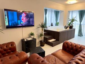 a large living room with a tub and a tv at InspireNest Iulius Mall in Cluj-Napoca