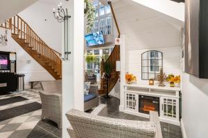a living room with a staircase and a fireplace at Luxury Jacuzzi Suite with Sauna & Heated Pool in Shanty Bay