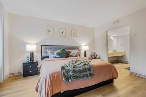 a bedroom with a large bed and two lamps at Luxury Jacuzzi Suite with Sauna & Heated Pool in Shanty Bay +37 photos