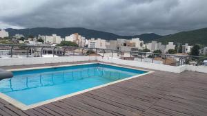 a swimming pool on the roof of a building at Spacious Studio in Alsina in Salta