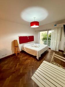 a bedroom with a bed and a large window at Spacious Studio in Alsina in Salta